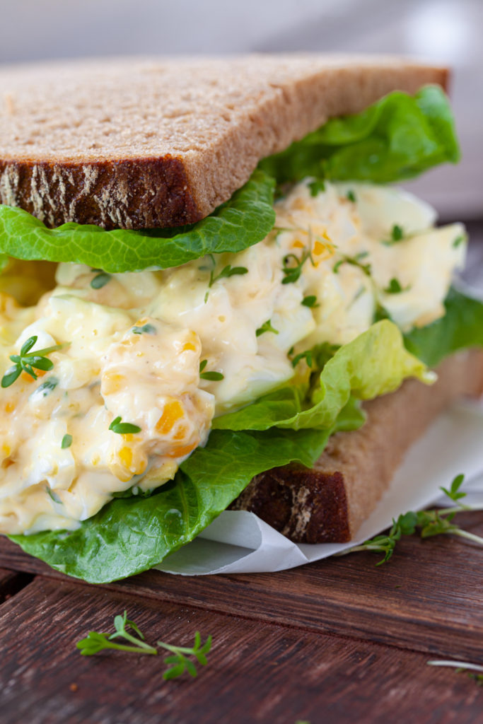 Slices of bread with homemade egg salad and lettuce