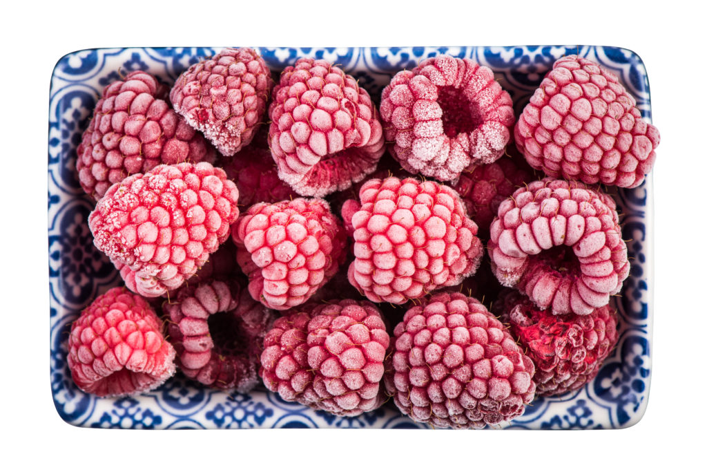 Frozen raspberry fruits, close up.