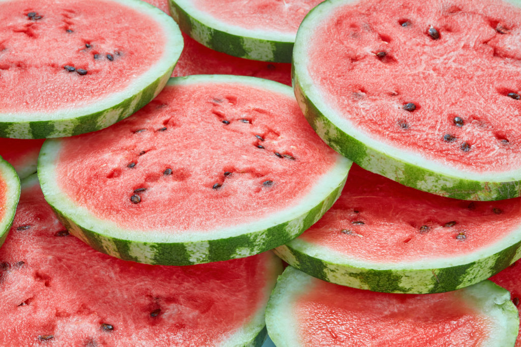 Heap of fresh sliced watermelon as textured background